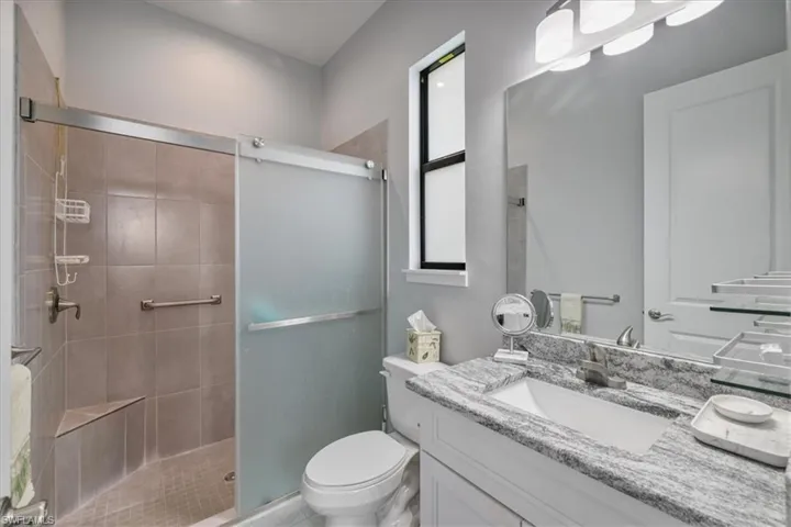 Full bath featuring vanity and a shower stall