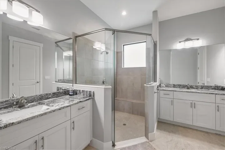 Bathroom with a stall shower and two vanities