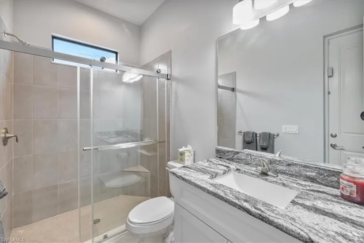 Bathroom featuring a stall shower and vanity