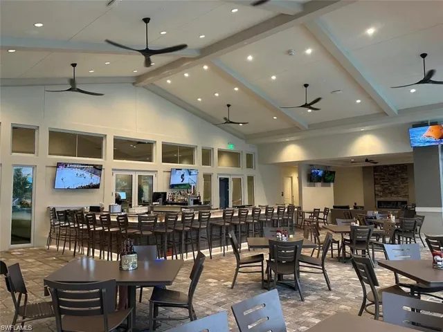 Dining area with french doors, high vaulted ceiling, beamed ceiling, and ceiling fan