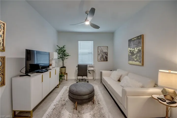 Tiled living room featuring ceiling fan