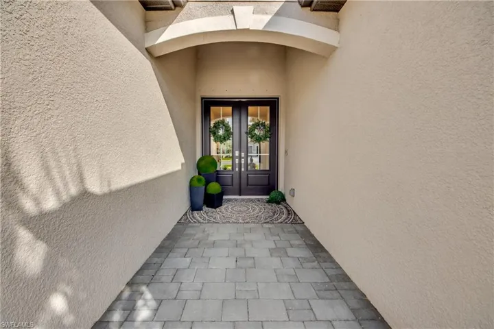 Property entrance featuring french doors