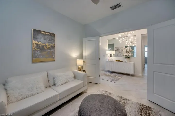 Tiled living room featuring a chandelier