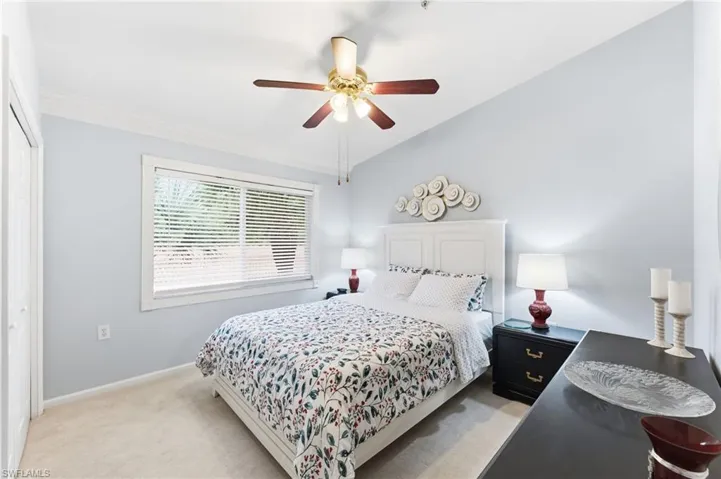 Bedroom with light carpet, a ceiling fan, a closet, and lofted ceiling