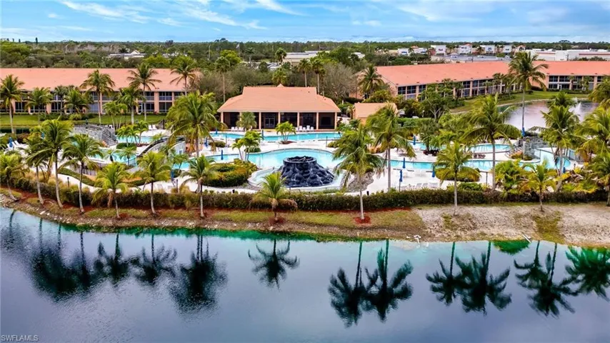 Aerial view of a pool and a nearby body of water