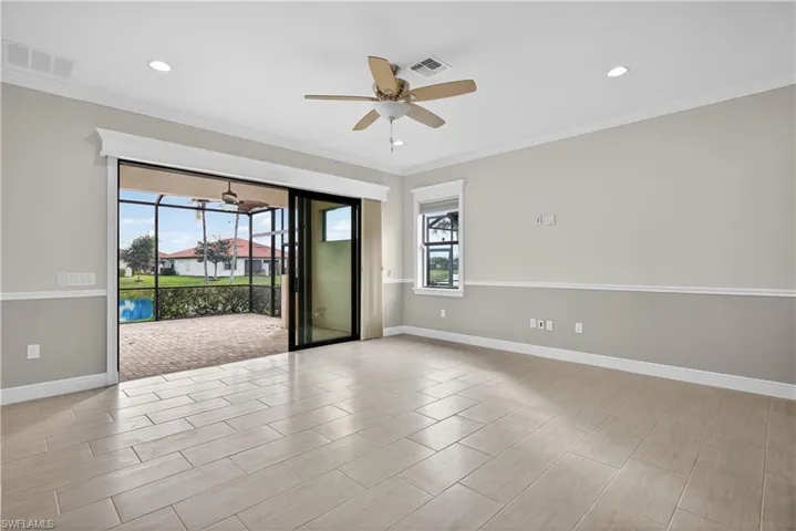 Spacious great room with, recessed lighting, tile floors and tranquil lake views.
