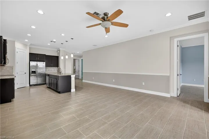 Open floor plan, recessed lighting, and tile floors