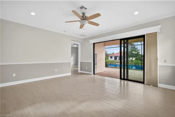 Spacious great room with, recessed lighting, ceiling fan/light tile floors and tranquil lake views.
