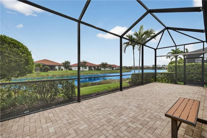 Screened lanai plumbed for an outdoor kitchen, ceiling fan and tranquil lake views.