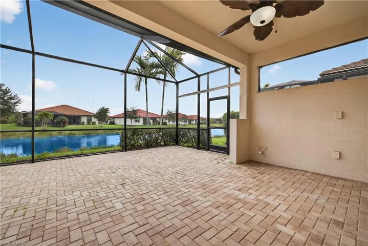 Screened lanai plumbed for an outdoor kitchen, ceiling fan and tranquil lake views.