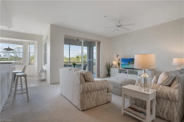 Living room featuring a healthy amount of sunlight and ceiling fan