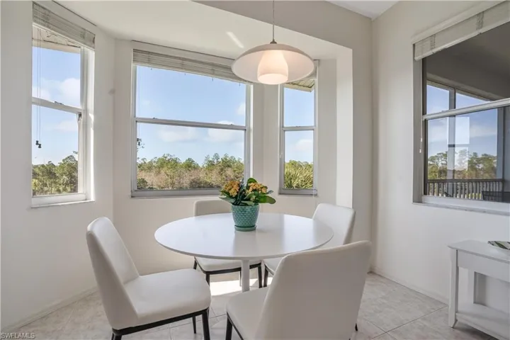 Dining space with light tile patterned floors