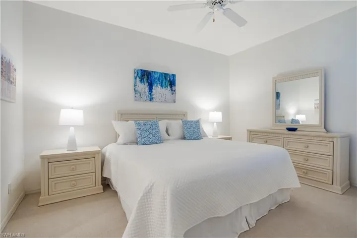 Bedroom featuring light colored carpet and ceiling fan