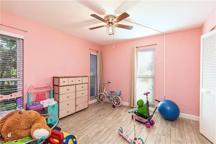 Game room featuring light wood-type flooring, baseboards, and ceiling fan