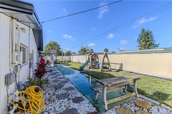 View of yard with a playground and a fenced backyard
