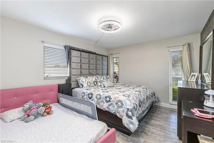 Bedroom with baseboards and wood finished floors