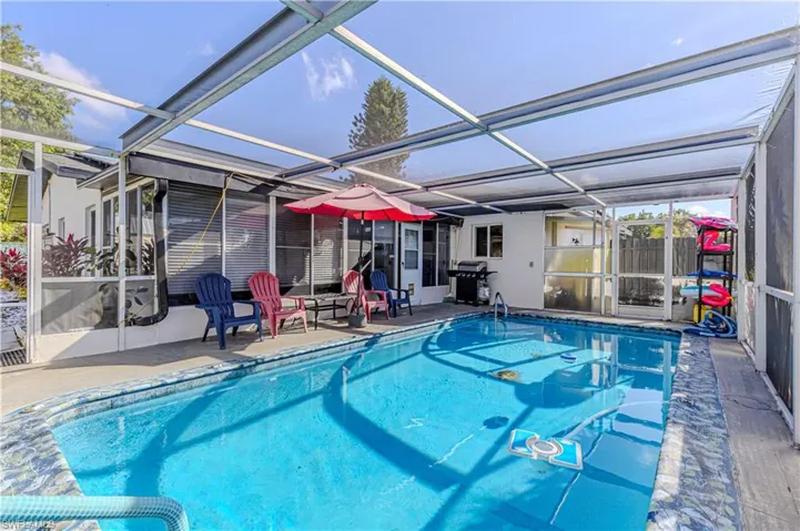 Outdoor pool featuring a patio, grilling area, and a lanai