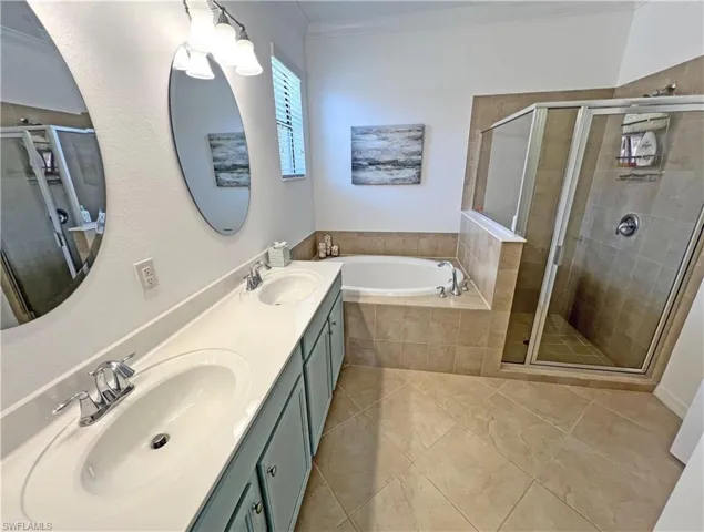 Master bathroom featuring duals sinks and separate tub and shower