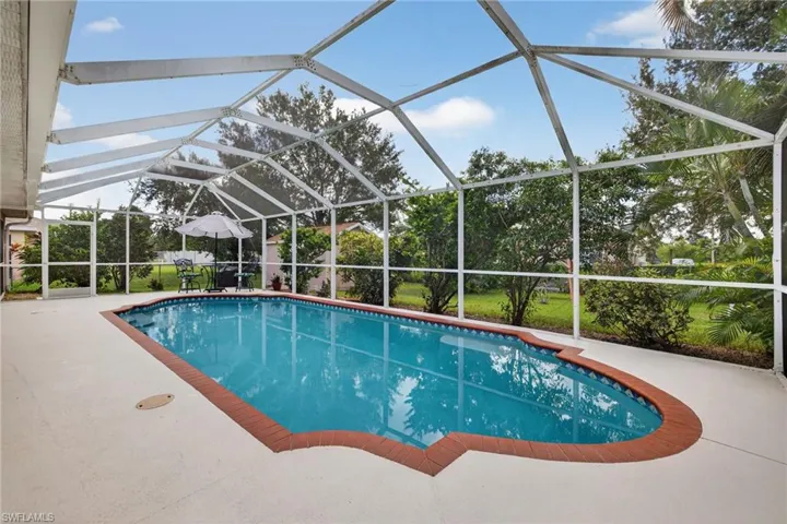 Outdoor pool featuring a lanai, a sunroom, and a patio
