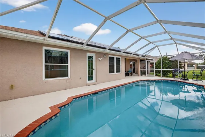 Swimming pool featuring a sunroom, a lanai, and a patio area