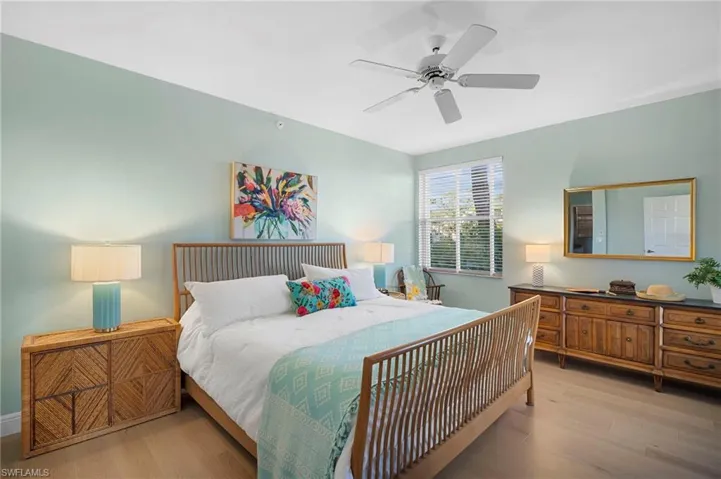 Bedroom featuring Mirage wood floors floors and a ceiling fan