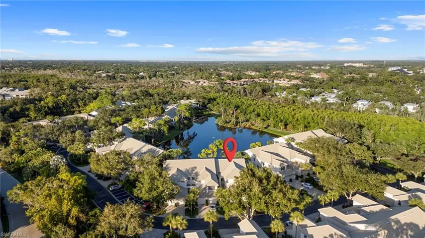 Aerial view of property and surrounding area featuring nearby suburban area