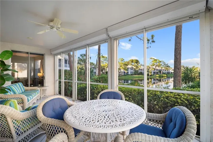 Sunroom / solarium with a water view and a residential view