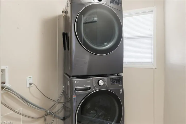 Laundry room featuring stacked washer / dryer