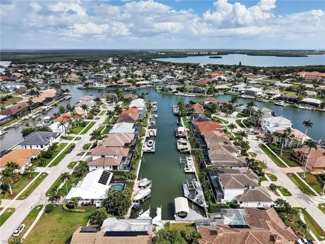 Aerial view of property's location with nearby suburban area and a large body of water