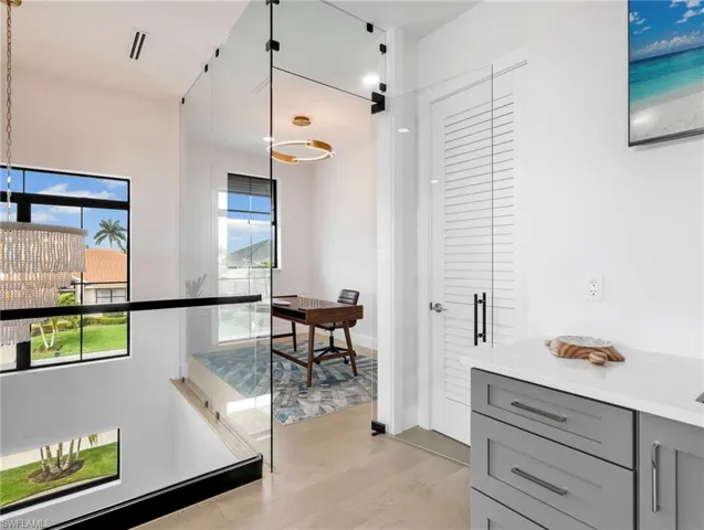 Corridor featuring light wood-style floors and baseboards