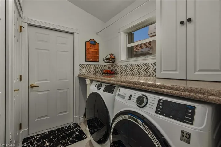 Laundry area featuring cabinet space and separate washer and dryer