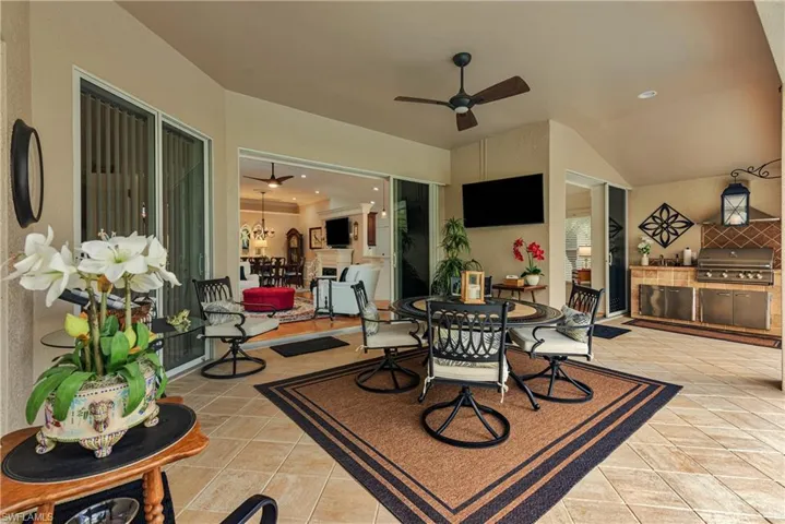 View of patio with outdoor dining area, a grill, an outdoor kitchen, and ceiling fan