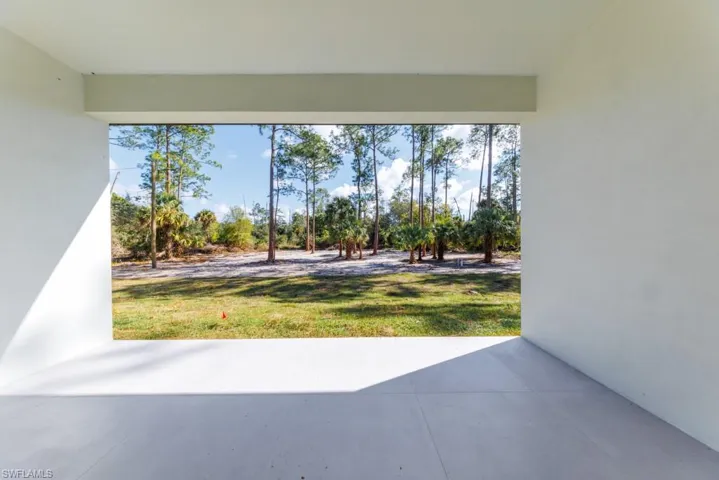 View of green lawn featuring a patio area