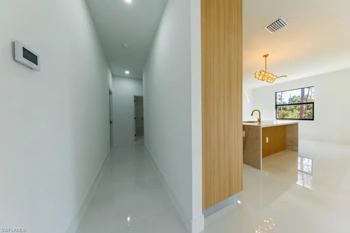 Hall featuring light tile patterned floors and recessed lighting
