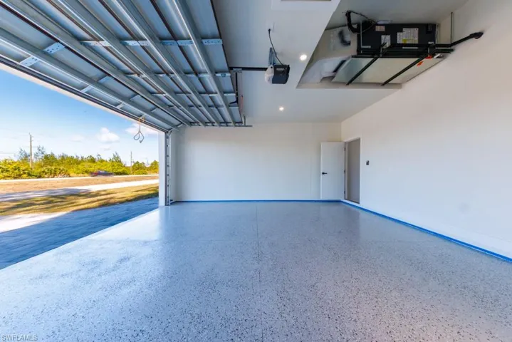 Garage with recessed lighting and a garage door opener