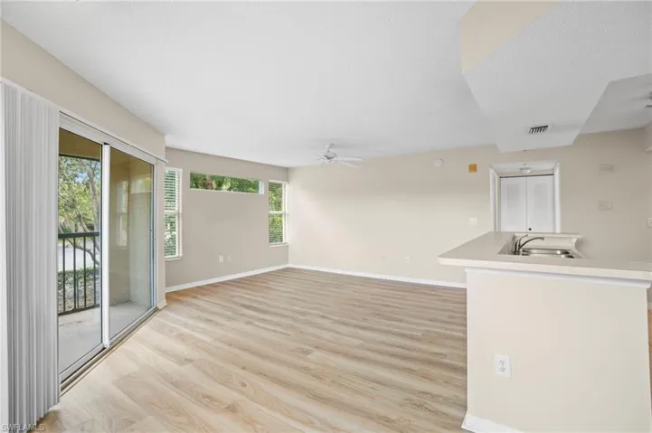Unfurnished living room featuring light wood finished floors and ceiling fan