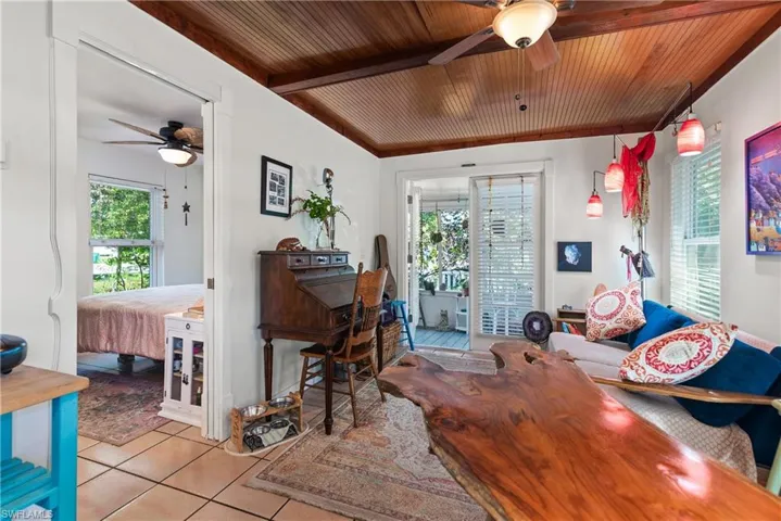 Kitchen featuring white cabinetry, stainless steel electric range oven, sink, and a wealth of natural light