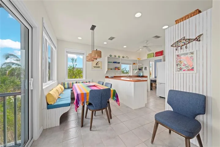 Dining area with recessed lighting, light tile patterned flooring, and a ceiling fan