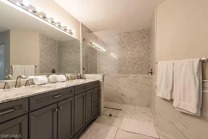 Double vanity with a light-toned countertop, dual undermount sinks, and brushed nickel fixtures