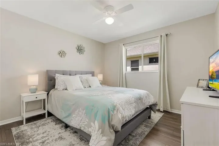 Wood-finish flooring, ceiling fan, window with natural light, neutral wall colors