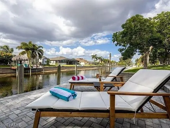 Paved patio with waterfront access and a built-in dock