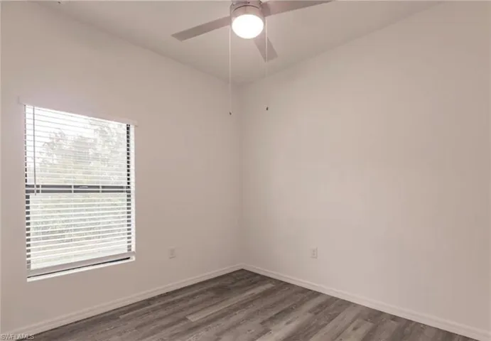 Neutral wall tones complemented by wood-finish flooring