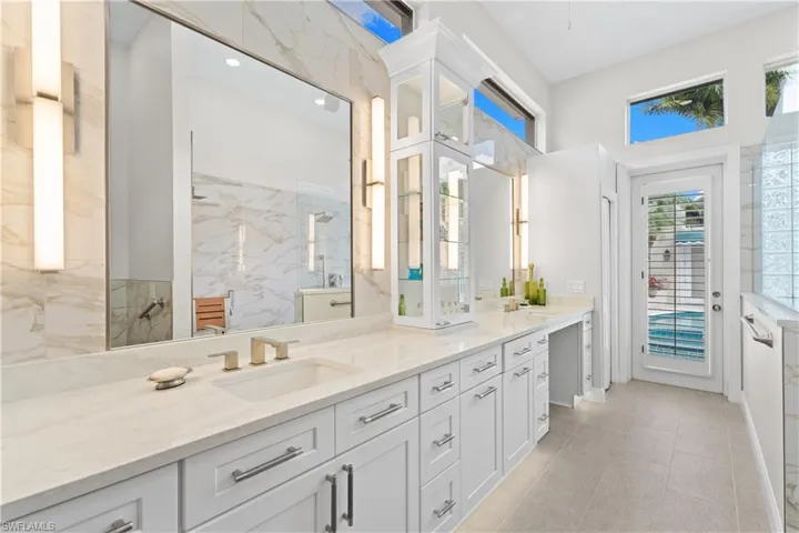 Newly renovated primary bath with double sinks, soft close cabinets,Walk in shower, separate water closet and beautiful tile work.