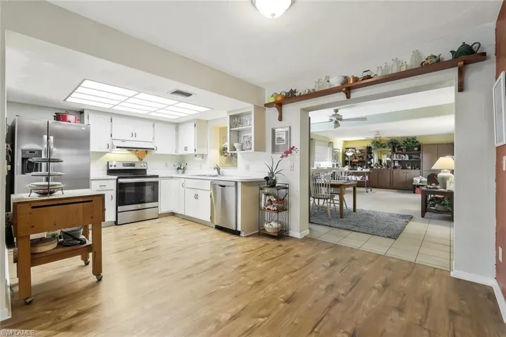Kitchen featuring light countertops, sink, light wood-style flooring, and appliances with stainless steel finishes