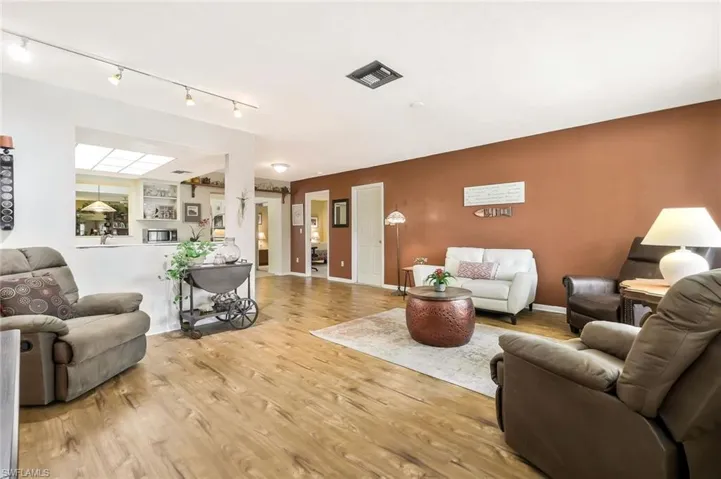 Living area featuring  wood finish floors, and rail lighting