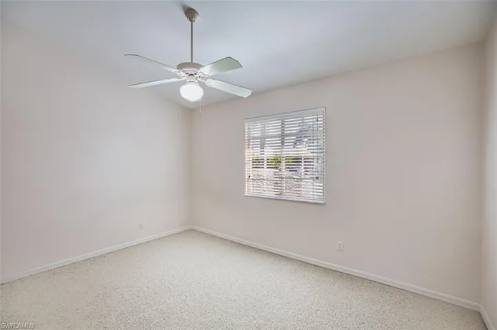 Bedroom with vaulted ceilings, Berber carpet, and a ceiling fan