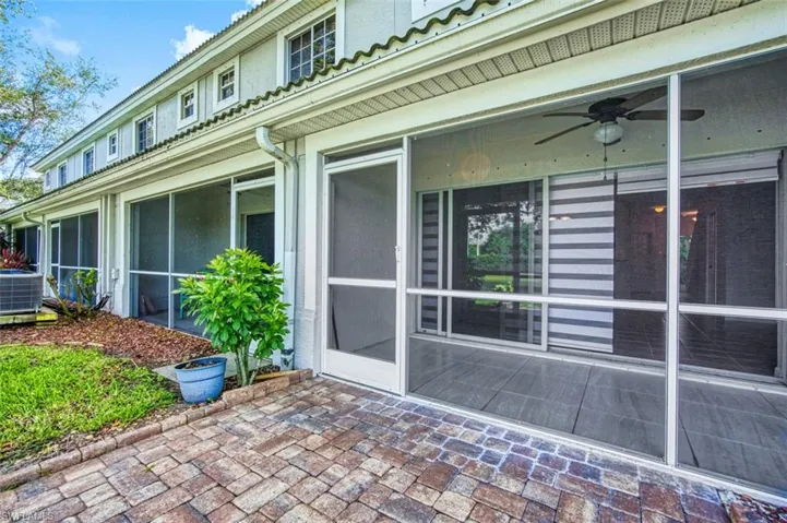 View of home's exterior with a sunroom and a ceiling fan