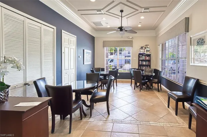 Community room featuring crown molding, recessed lighting, coffered ceiling, a ceiling fan, and light tile patterned floors