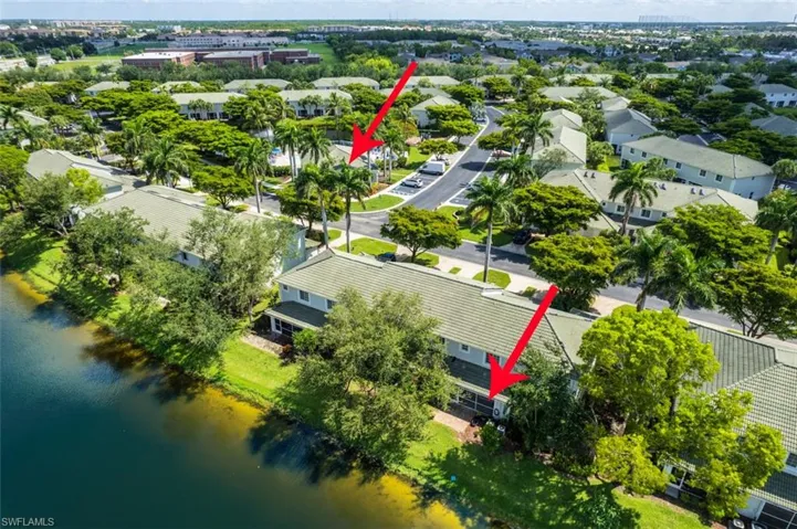Aerial perspective of suburban area featuring a nearby body of water