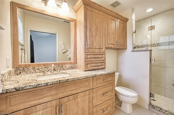 Full bathroom remodel by Conerstone Tile and Marble, vanity, a stall shower, tile patterned flooring, and recessed lighting, and multiple shower heads